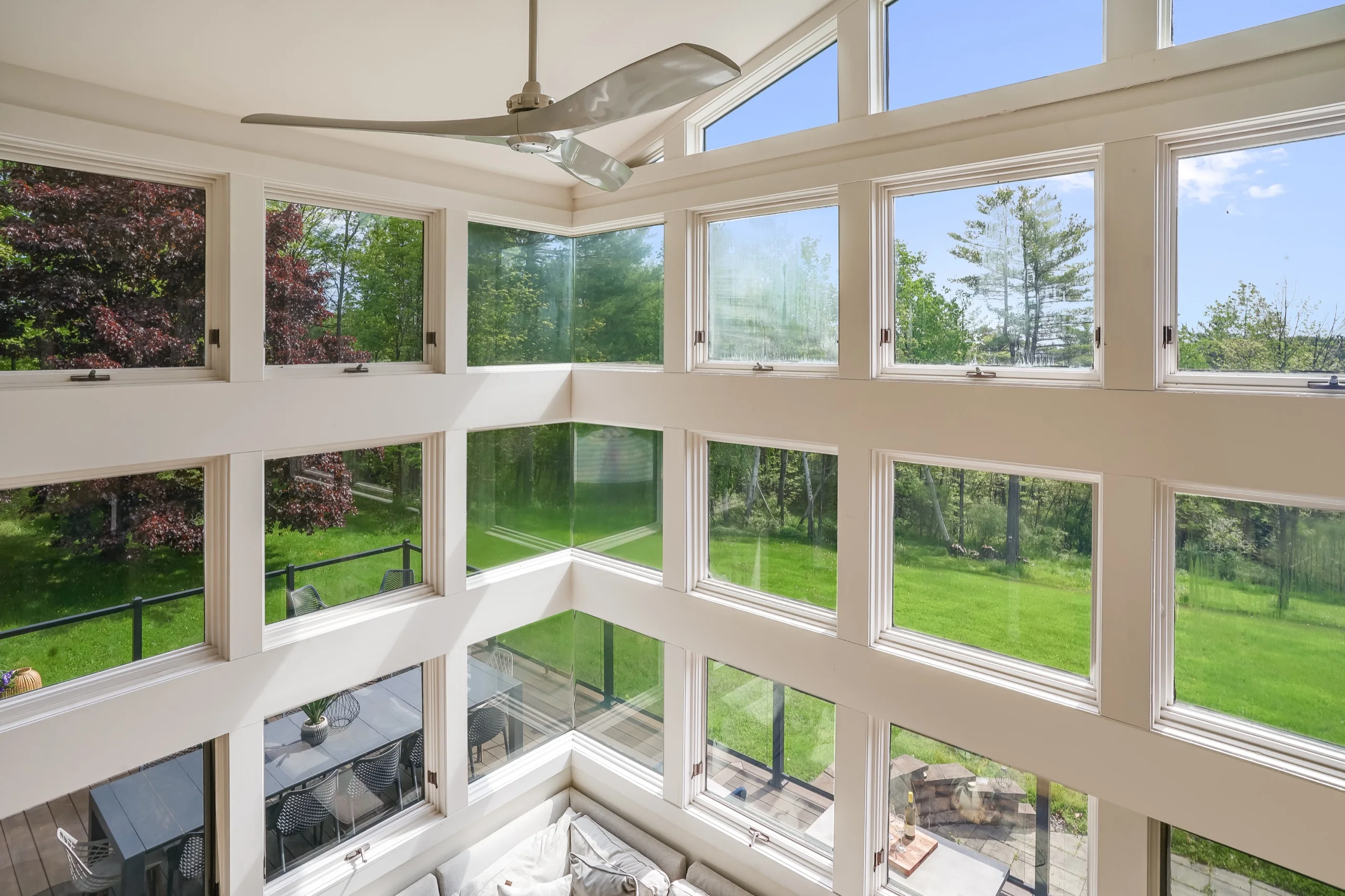 The window wall from the upper landing, glazing turning the corner high above the room below